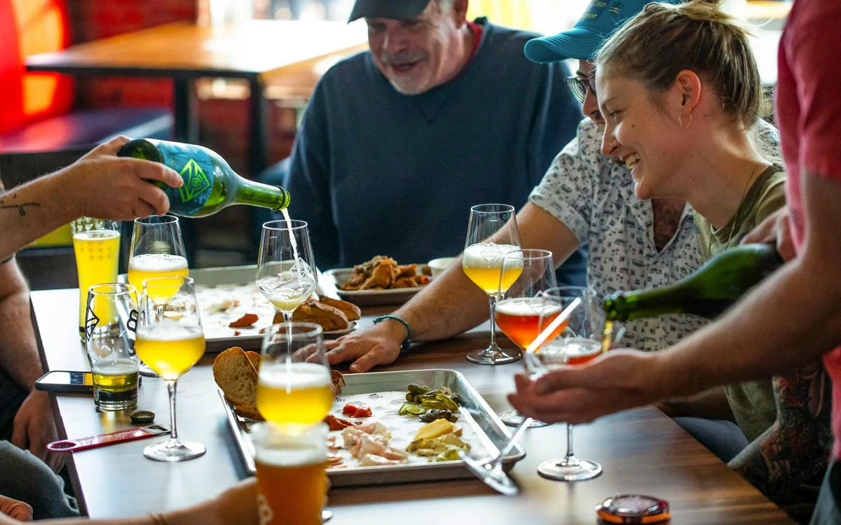 Guests sharing food and beer at Bissell Brothers