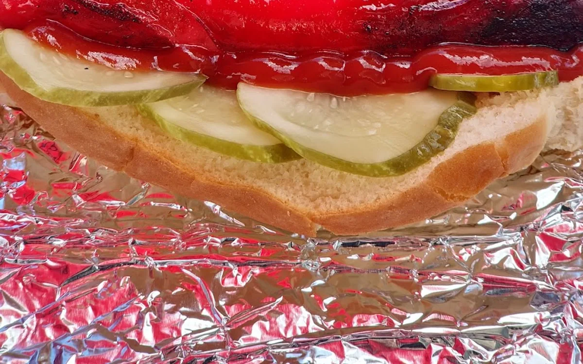 Red hot dog with pickles, onions and mustard from K & A’s Streetmeat in Portland, Maine