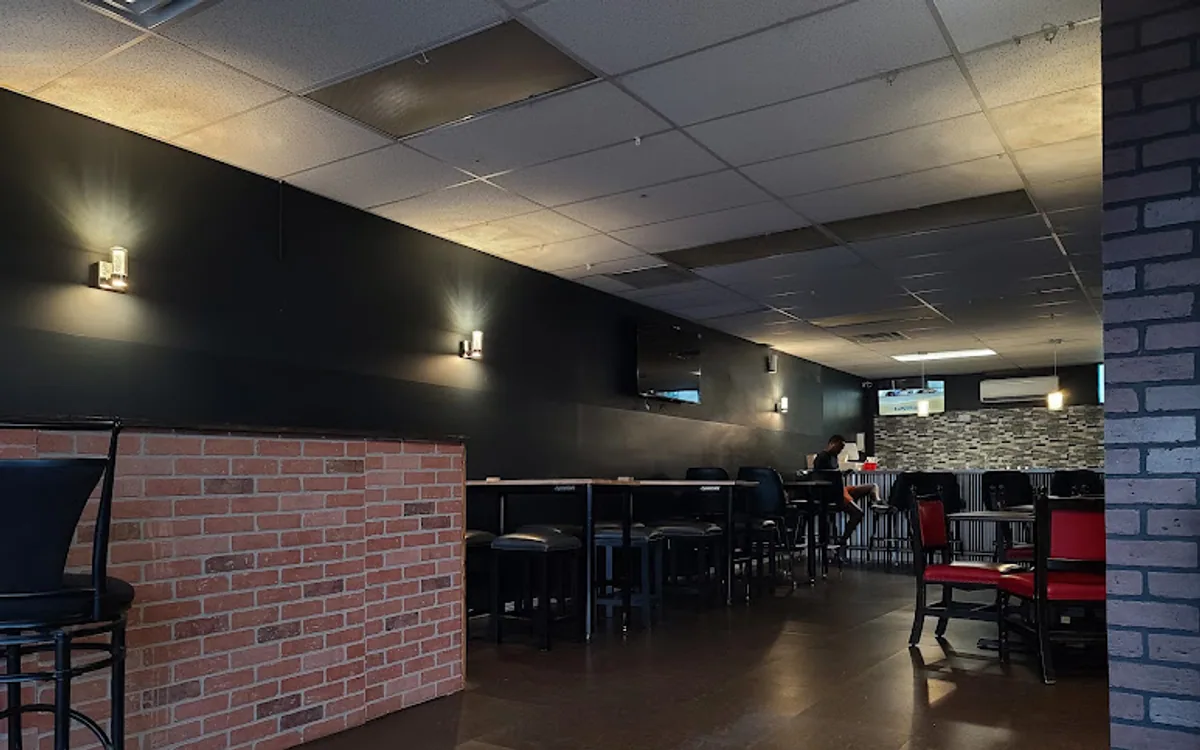 Seating and bar inside New Buja Belle on St John Street, Portland, Maine, photographed in 2023