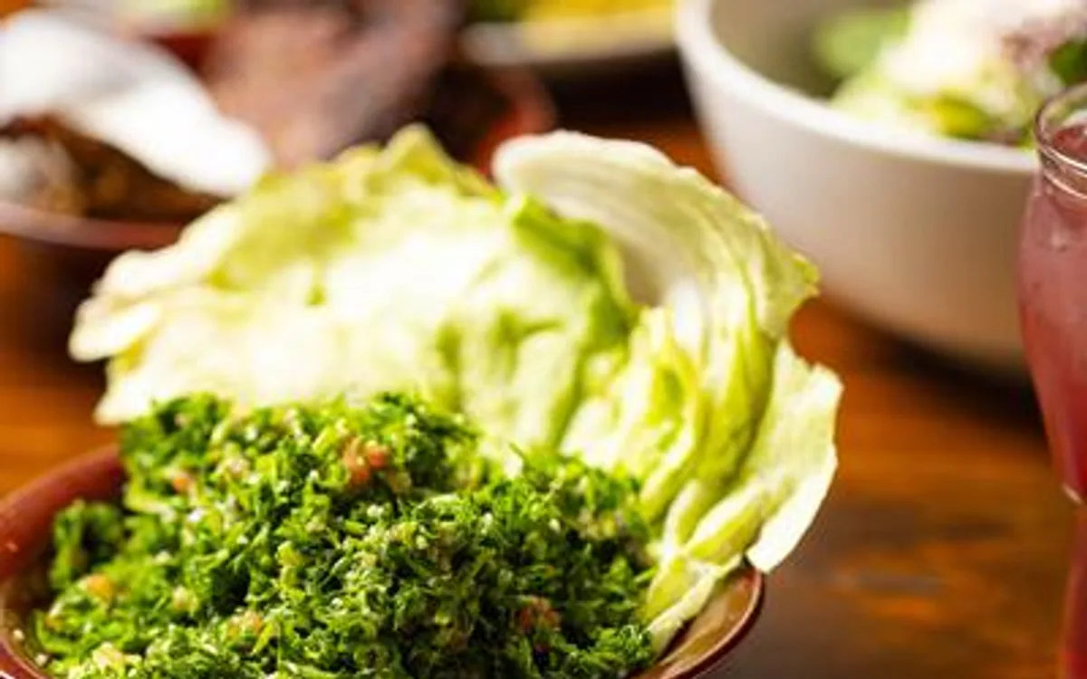 Tabouli salad plate surrounded by assorted food dishes.